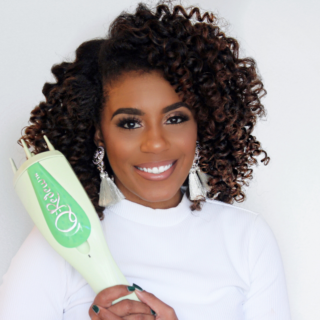 A woman with 3C curly hair holding a Q-Redew handheld hair steamer